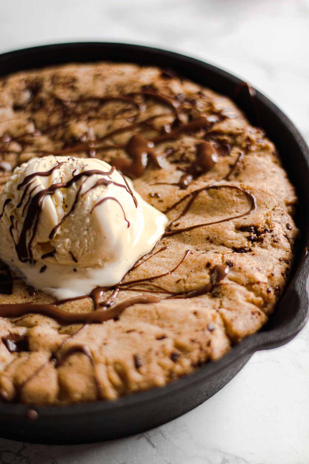 Close Up Of Cookie In A Skillet With Ice Cream On Top