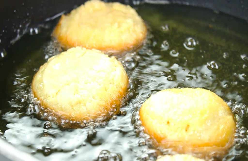 donuts frying in a pan