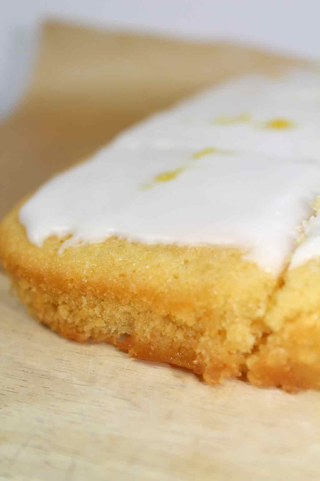 close up of lemon drizzle cake with icing