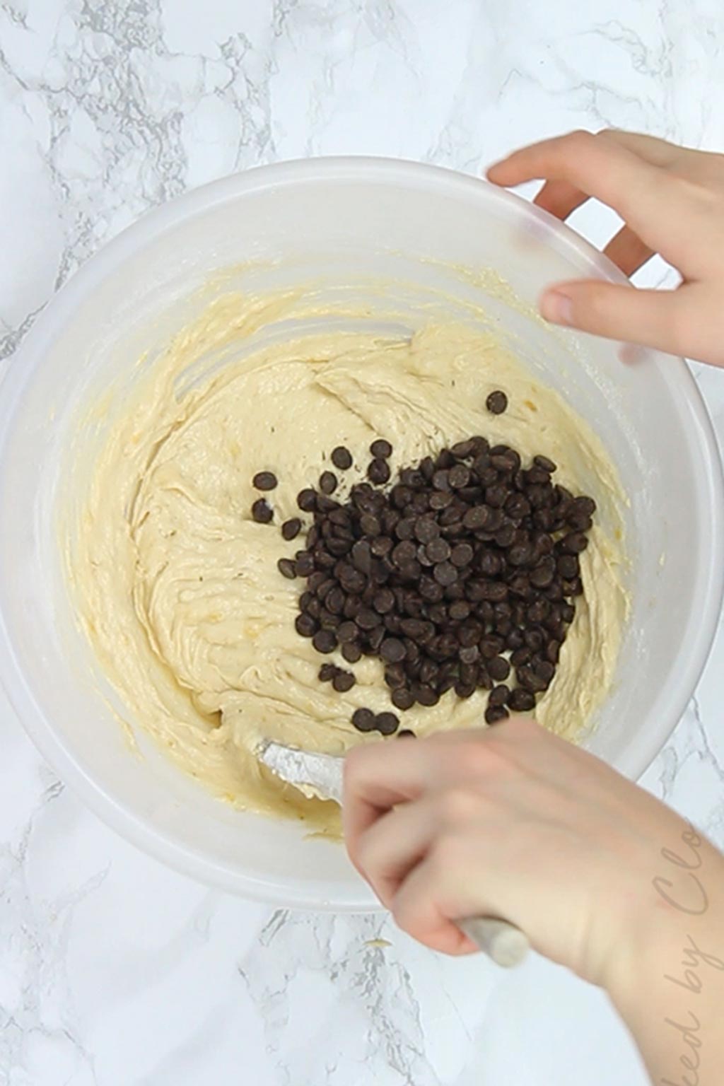 adding chocolate chips to the batter