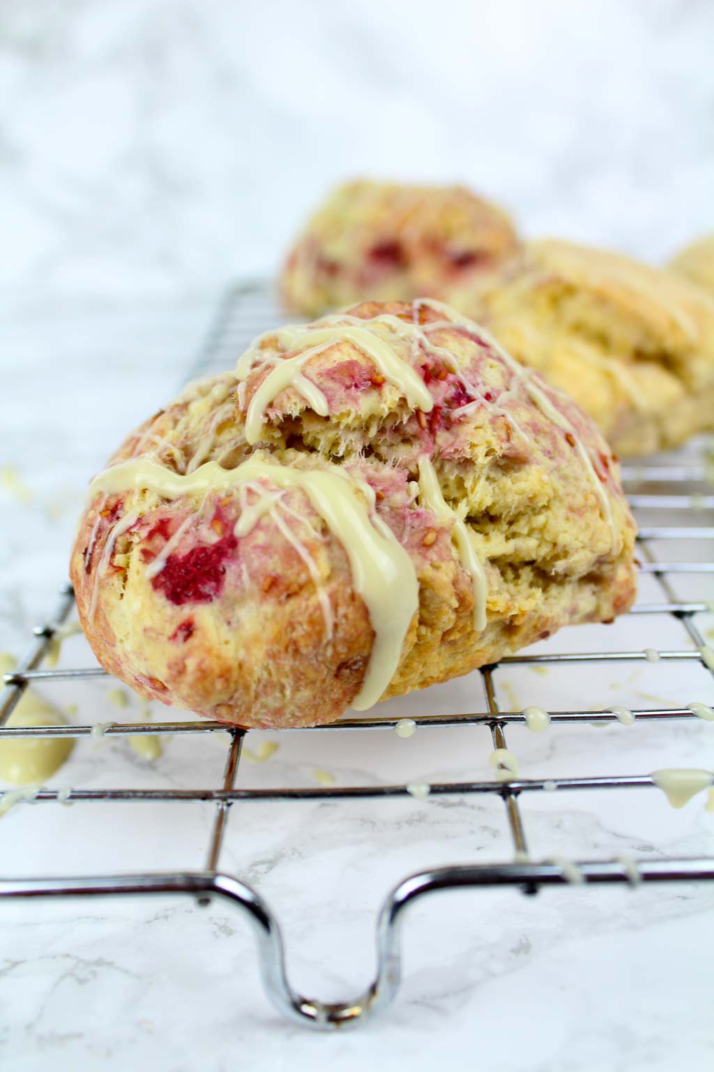 raspberry white chocolate scone on a cooling rack