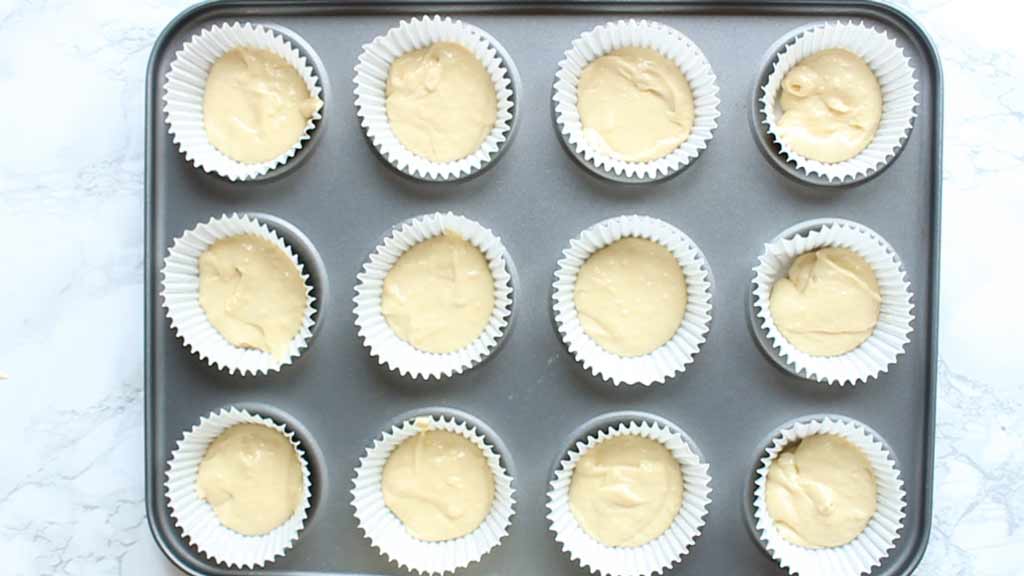 cupcake batter in liners on a tray