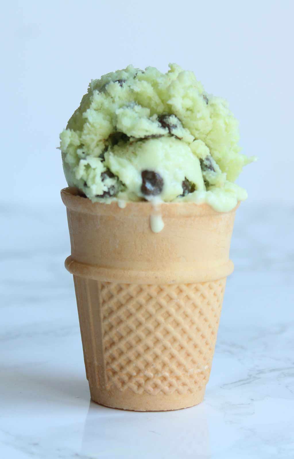 vegan mint choc chip ice cream in a cone
