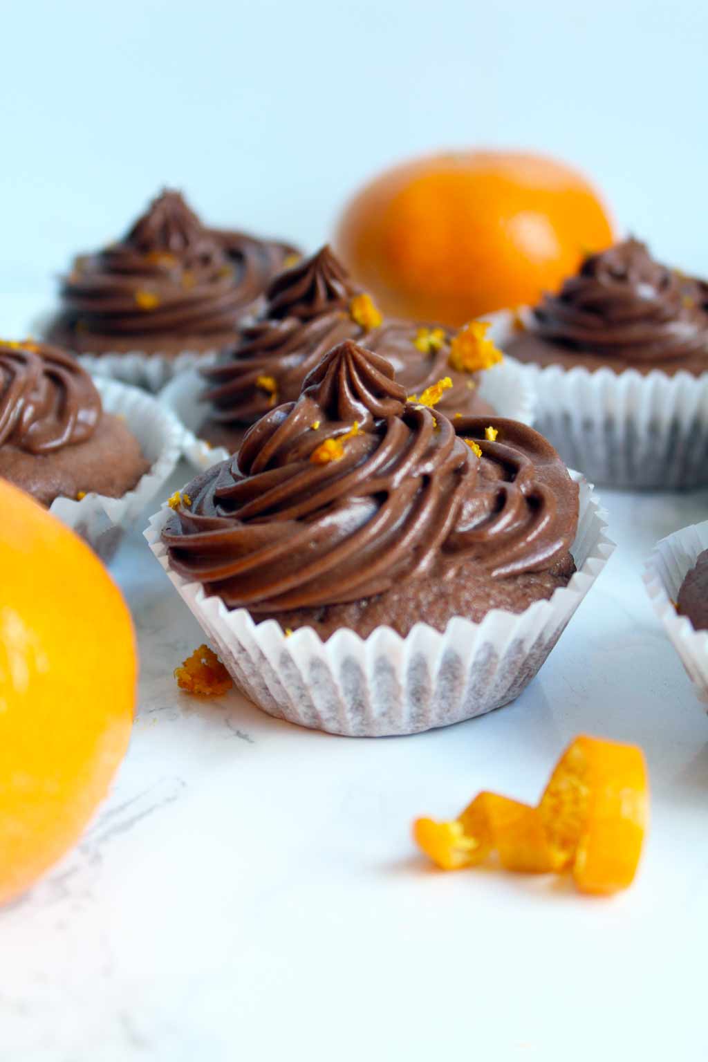 vegan chocolate orange cupcakes and two oranges