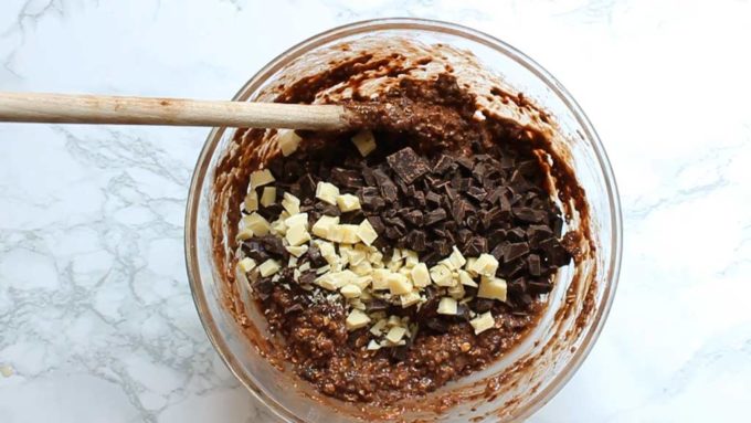 adding chocolate chunks to the brownie batter