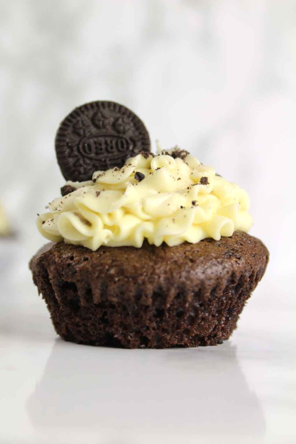 a vegan Oreo cupcake with the wrapper taken off