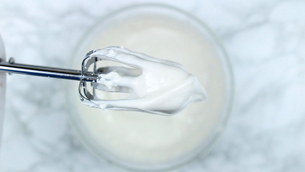 close up of meringue mixture on the end of whisk