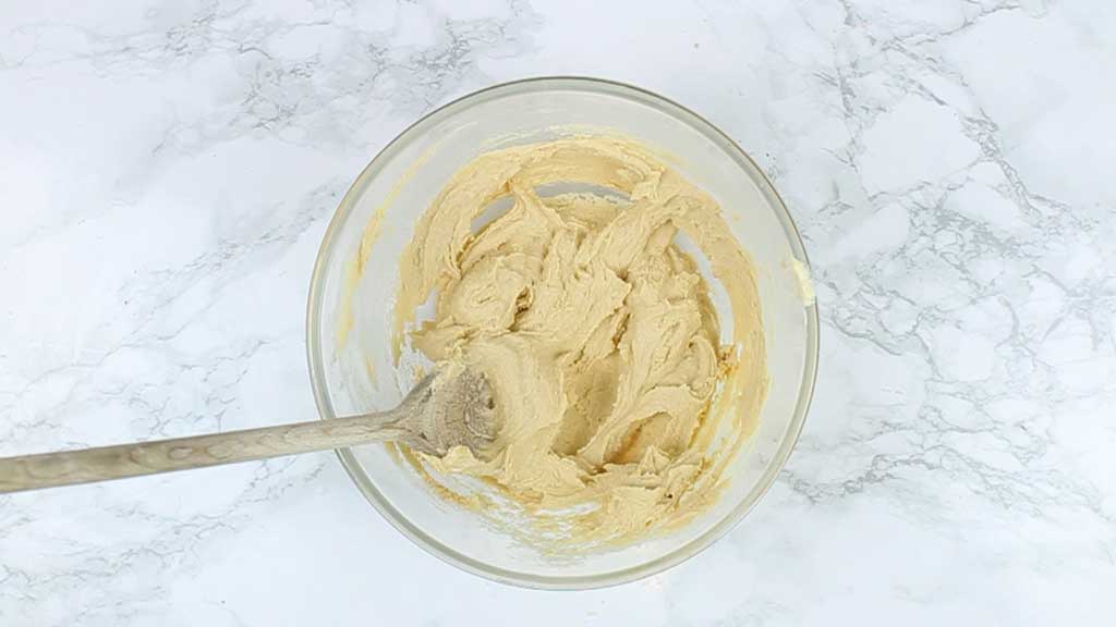 sugar and margarine mixed together in a glass bowl
