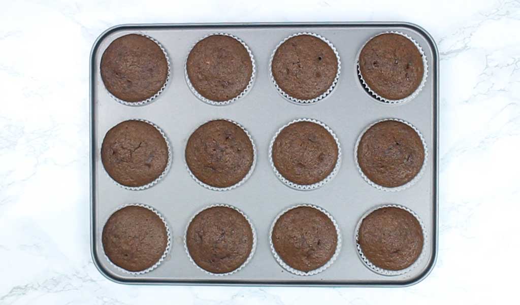 chocolate cupcakes cooling in a cupcake tin