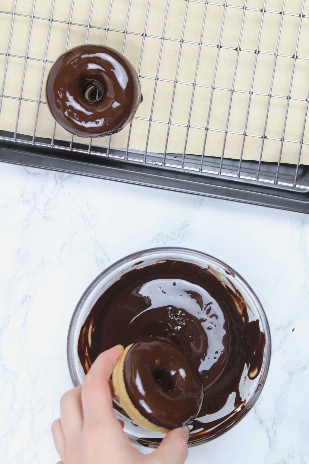 dipping donuts into melted chocolate