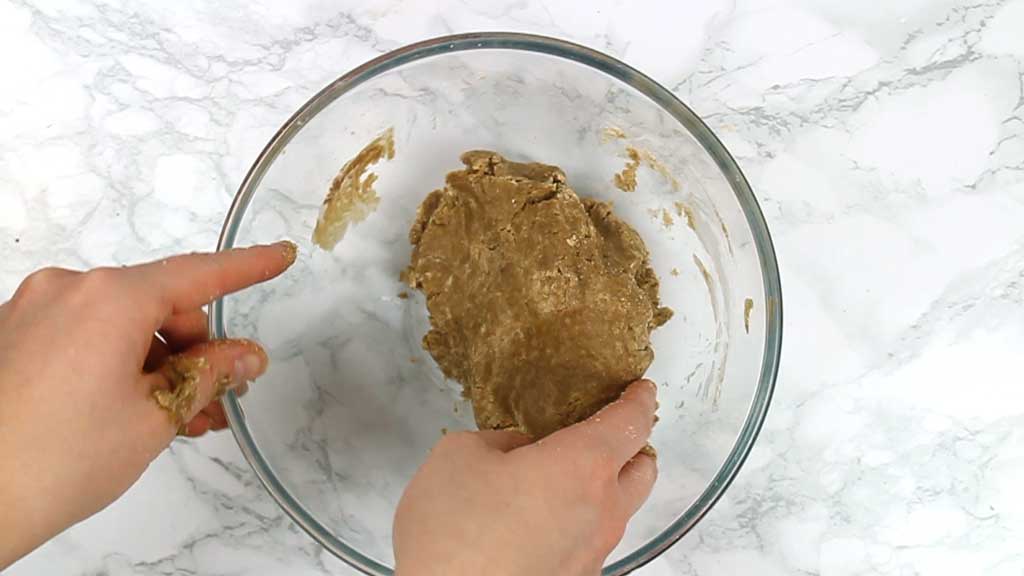 hands pressing the dough together 