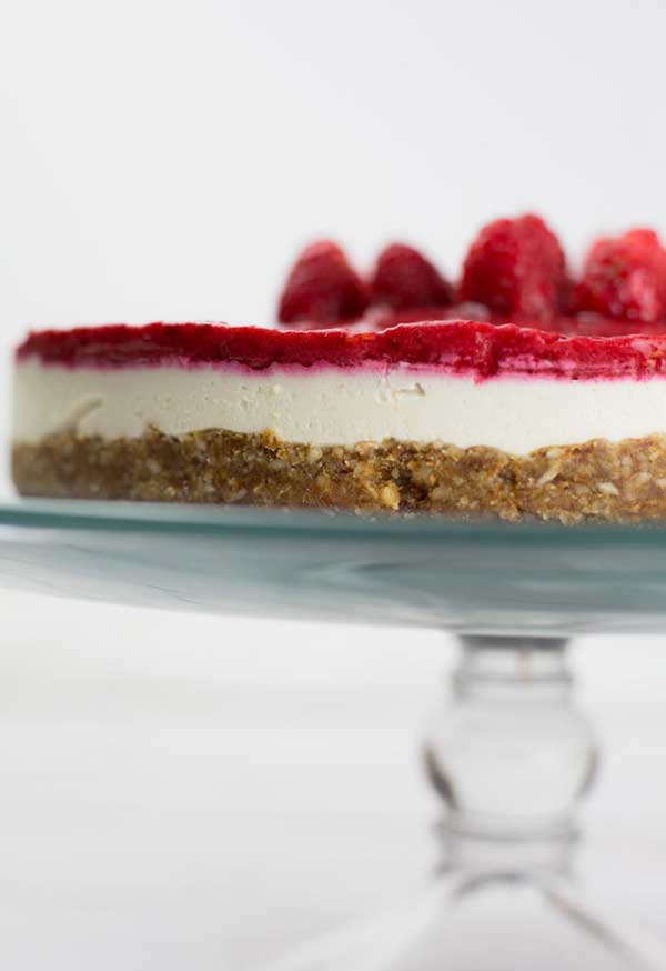 close up of raspberry cheesecake on a cake stand