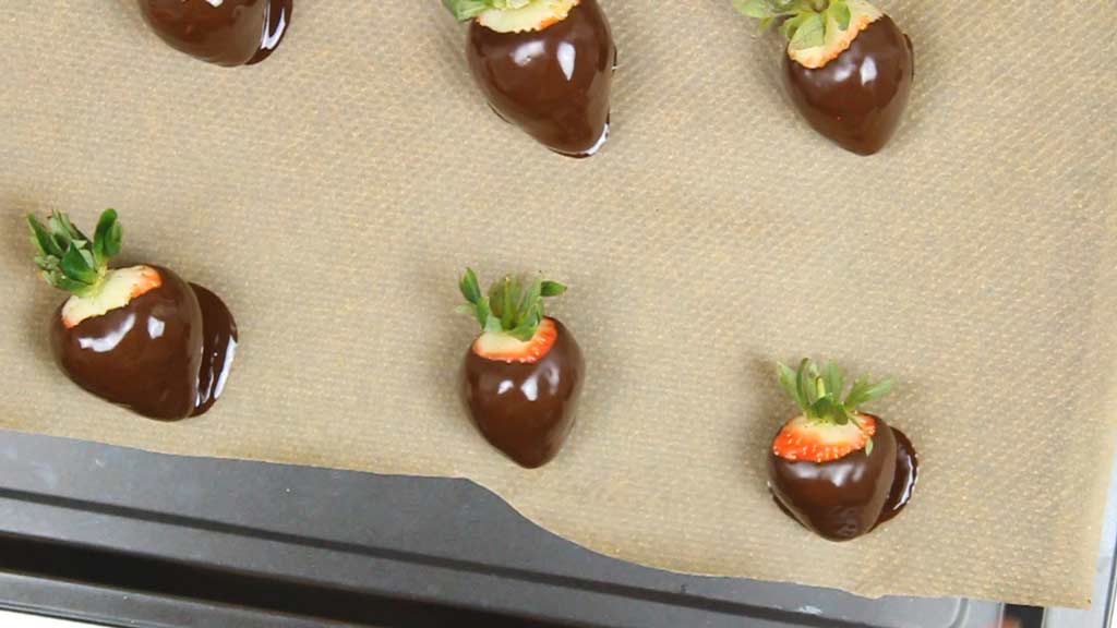 vegan chocolate covered strawberries on a line baking tray