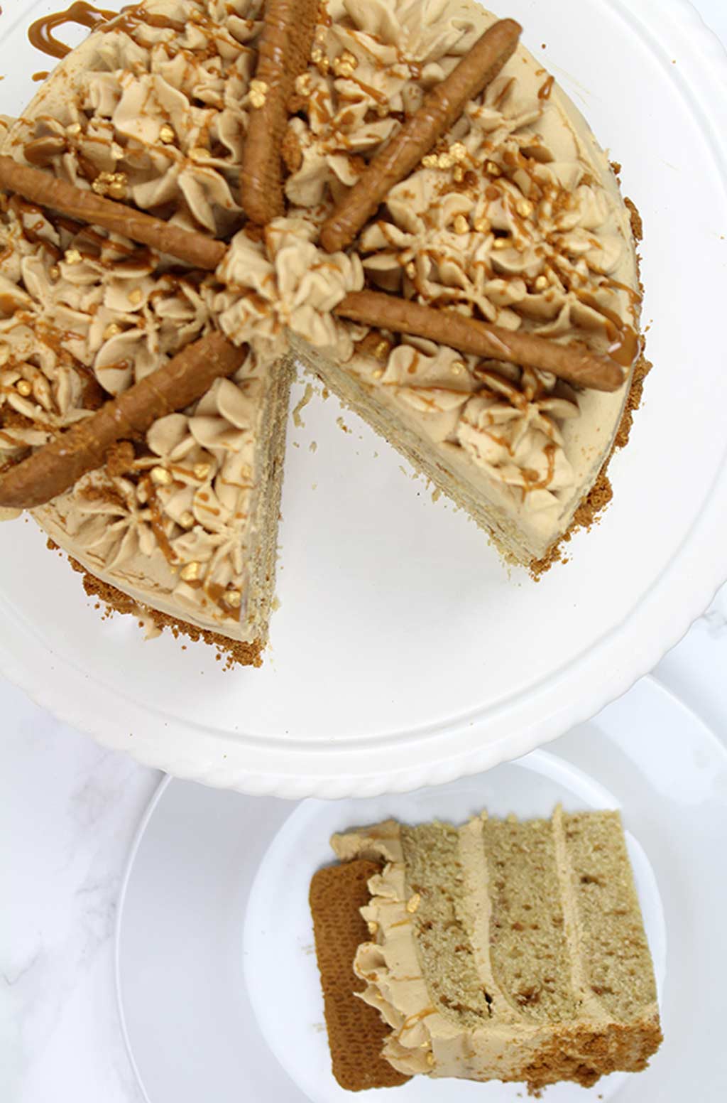 overhead shot of cake. One slice is on a plate and the rest is on a cake stand beside the plate