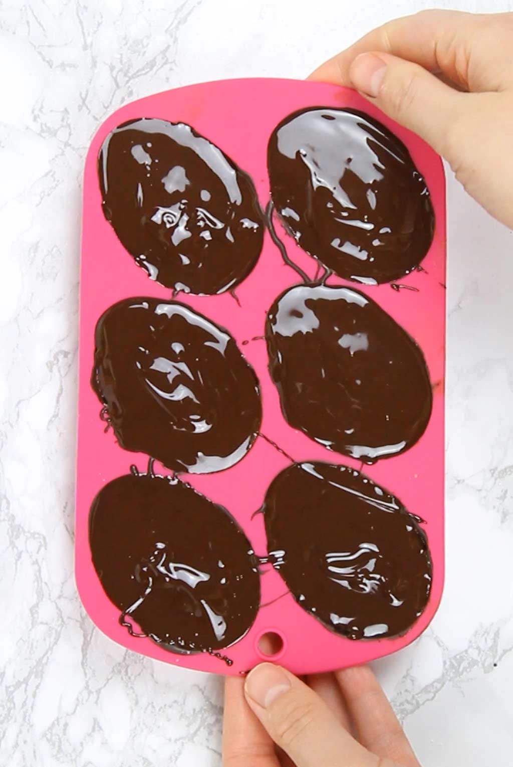 chocolate covered egg halves in the mold