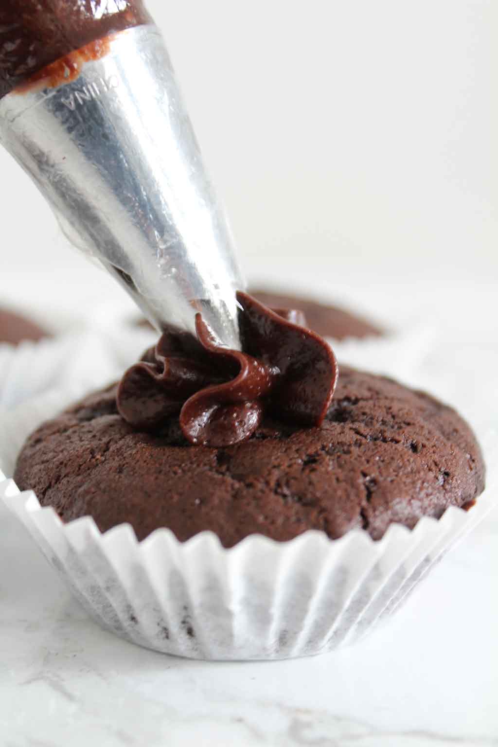 Piping Frosting Onto Cupcake
