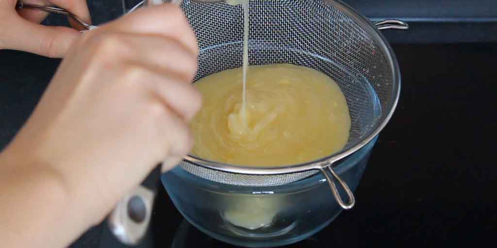 Straining The Curd Into A Bowl