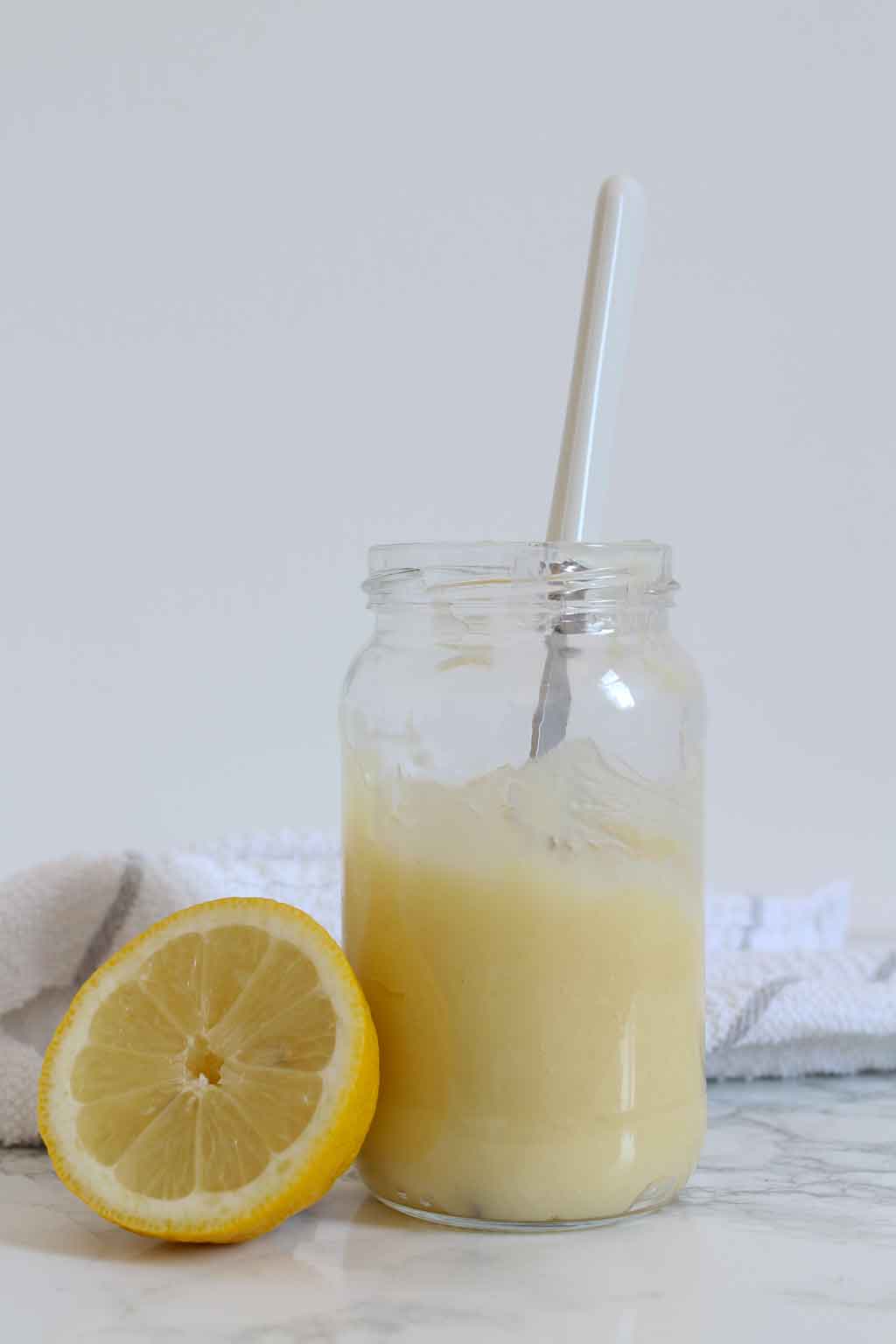 Vegan Lemon Curd in a jar with a knife in