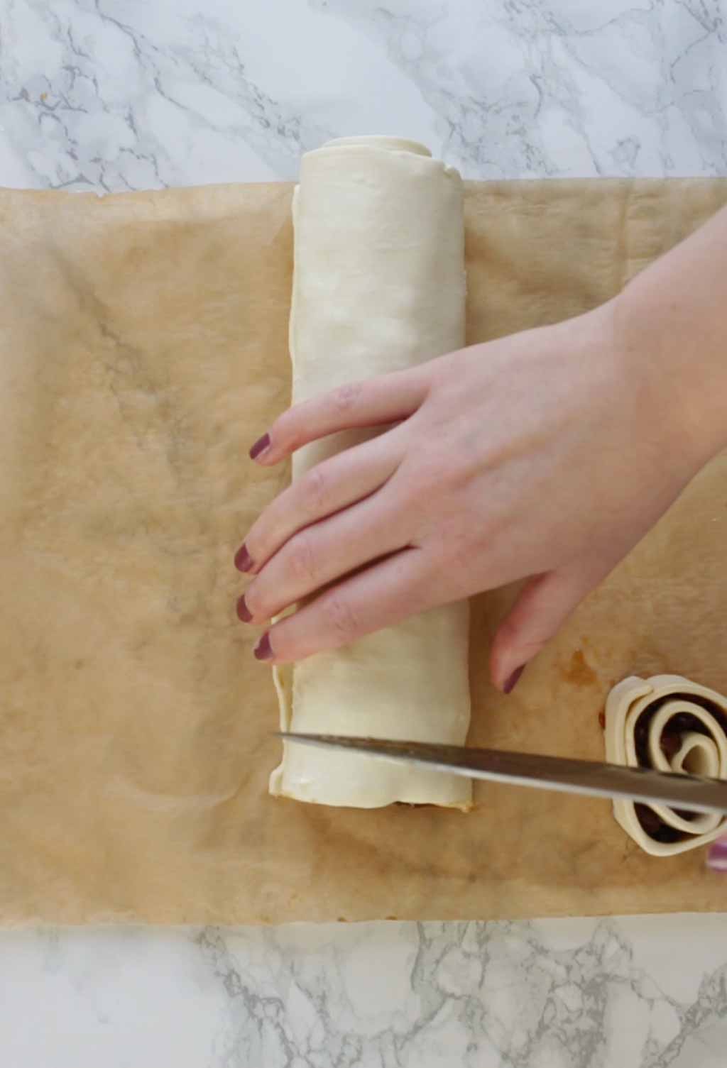 Cutting The Pastry Log Into Slices