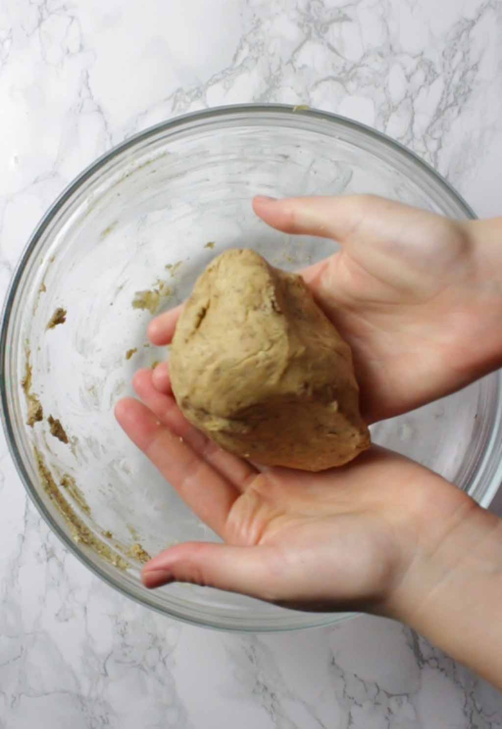Hands Holding A Ball Of Dough
