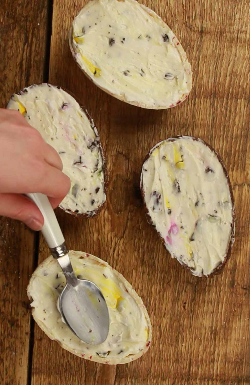 Smoothing Cheesecake Filling Into Chocoalte Eggs