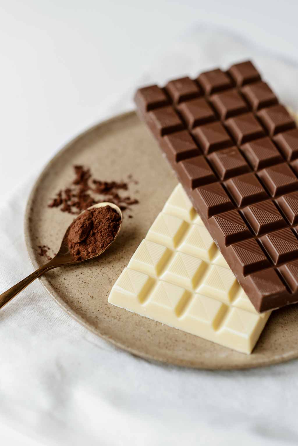 Is chocolate vegan? A dark chocolate bar on top of a white chocolate bar
