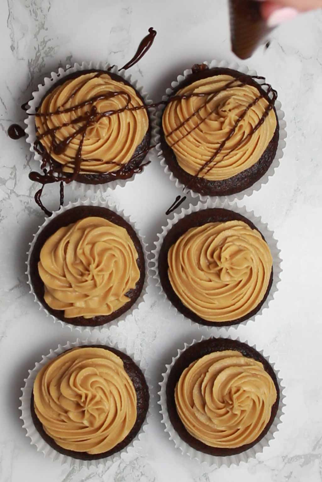 Drizzling Chocolate Over The Cupcakes