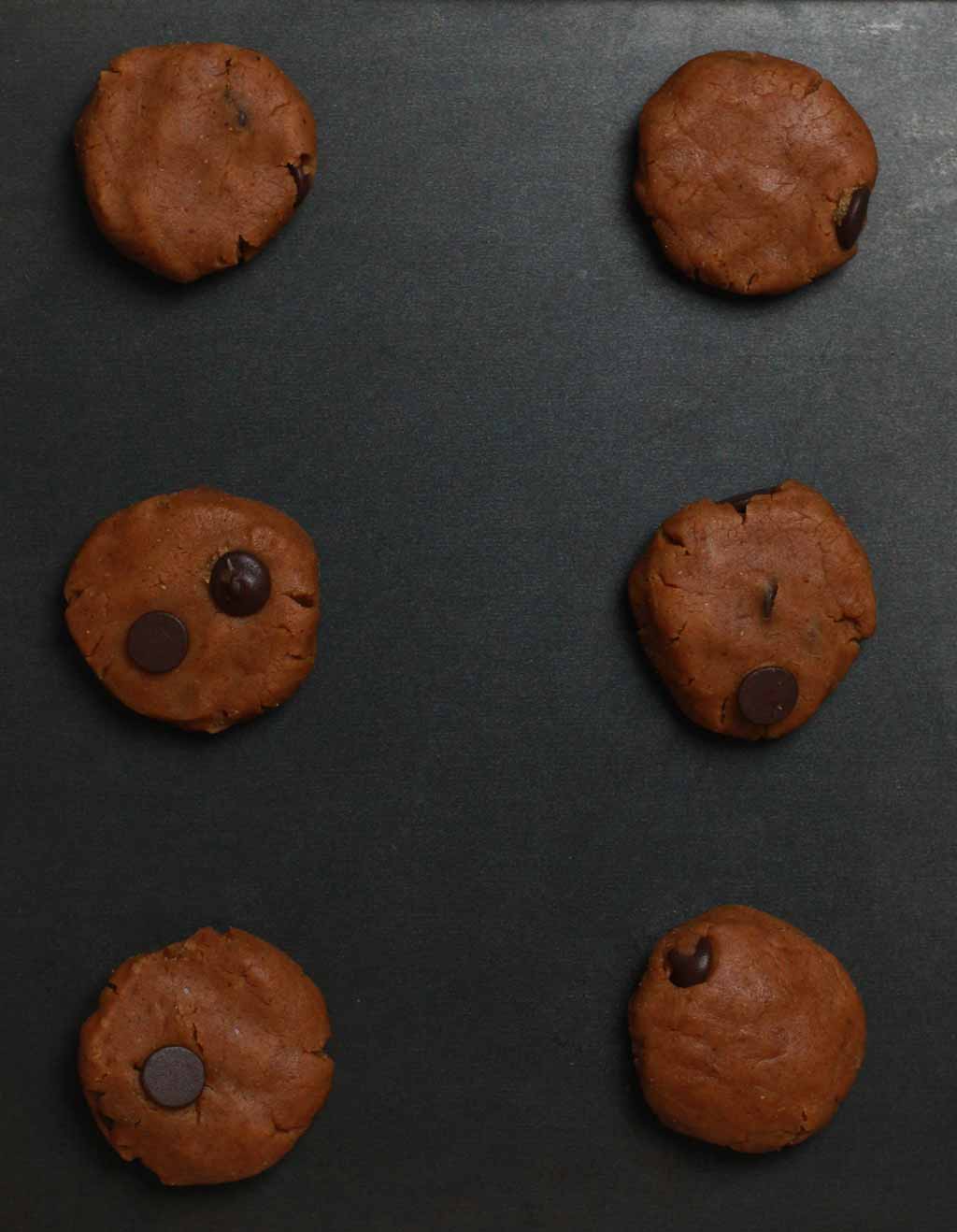 Balls Of Cookie Dough On A Non Stick Baking Tray