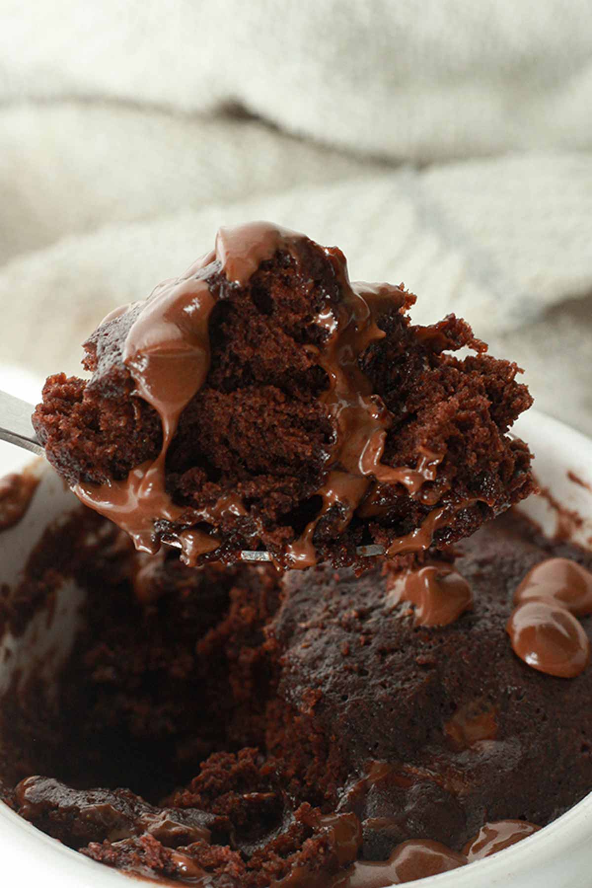 Chocolate Mug Cake With A Spoonful Taken Out Of It
