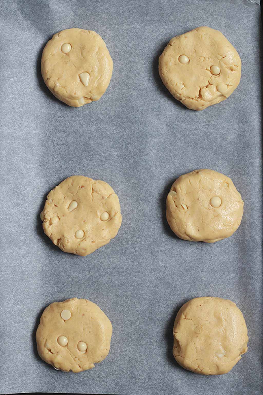 Discs Of Cookie Dough On A Baking Tray