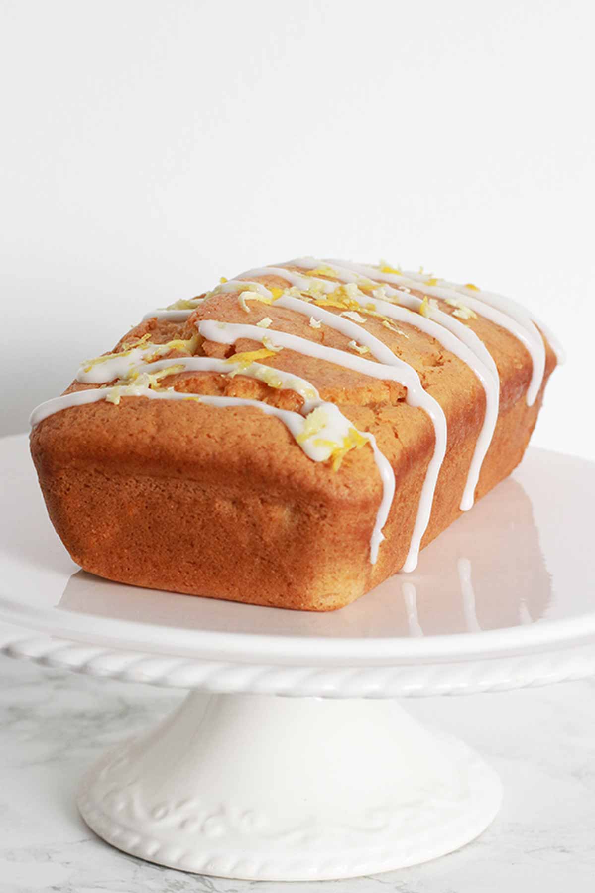 Vegan Lemon Drizzle Loaf With Icing Drizzled On Top