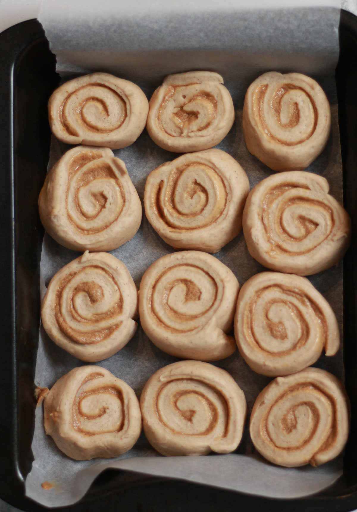 12 Unbaked Biscoff Cinnamon Rolls In A Tray