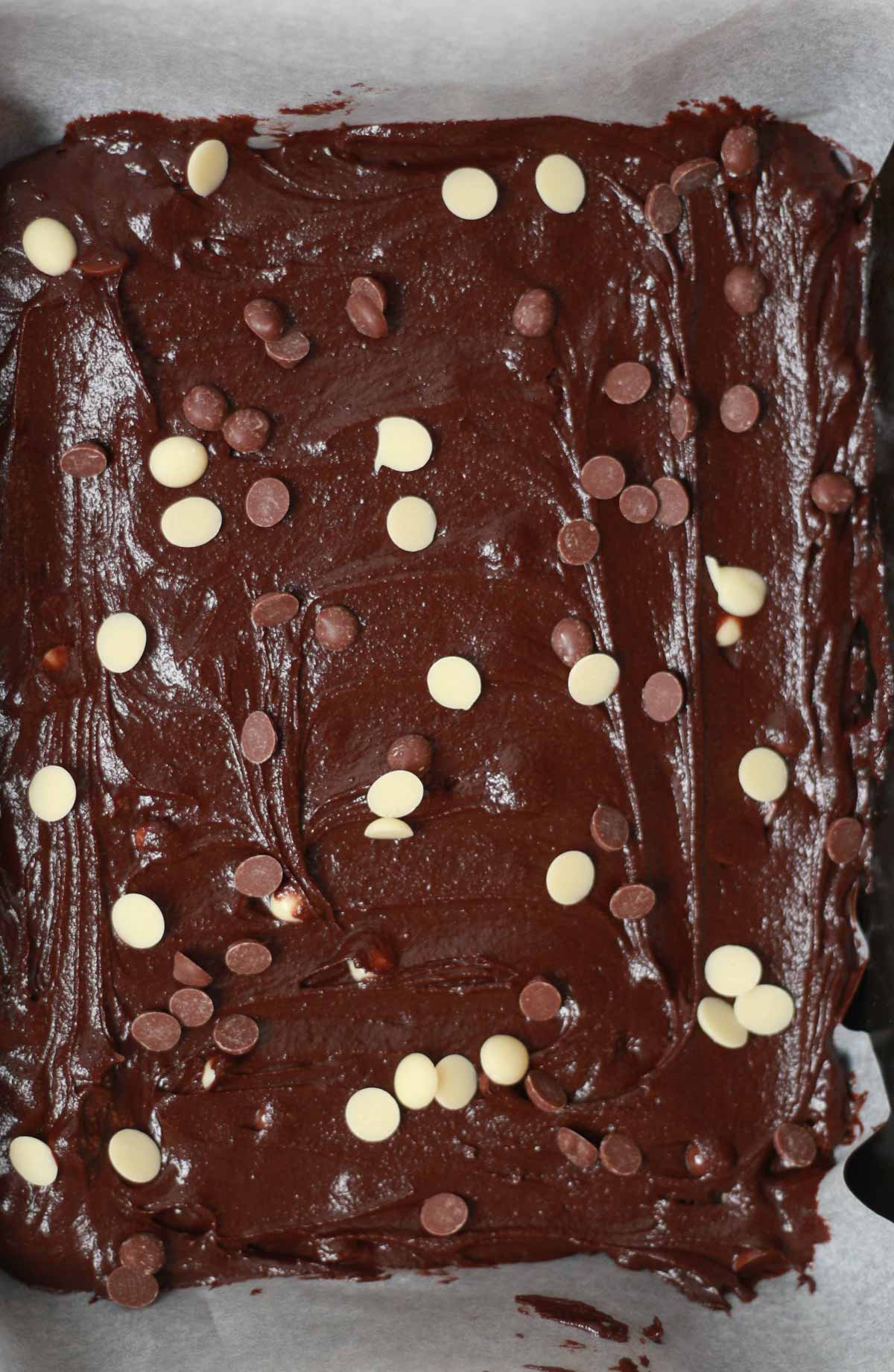 Batter In A Lined Tin With Chocolate Chips Sprinkled On Top