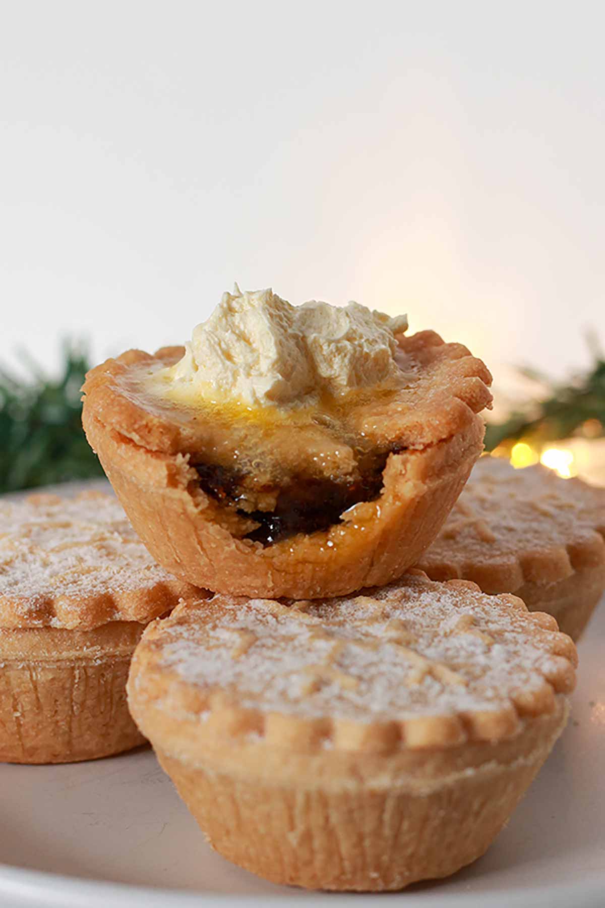 Mince Pie With A Bite Taken Out Of It And Brandy Butter On Top