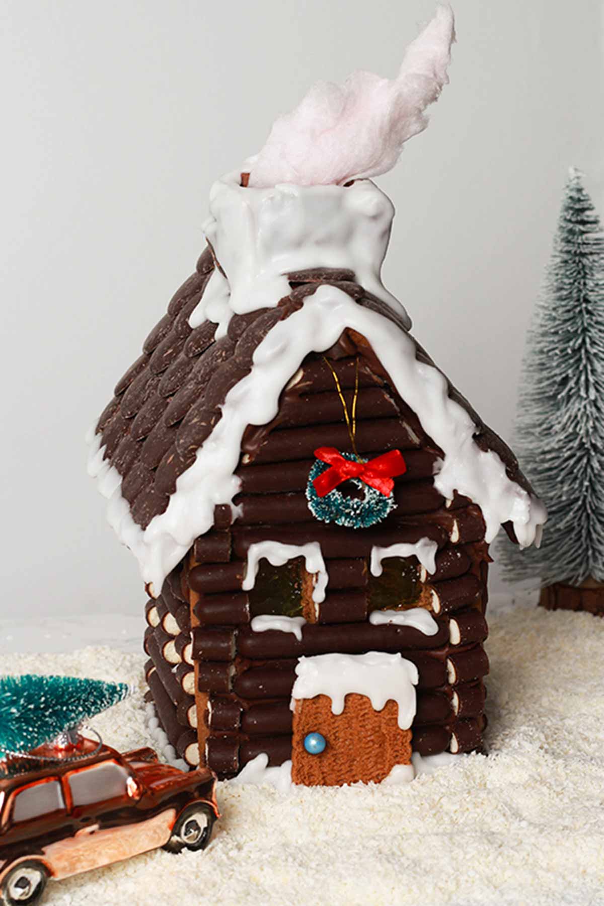Vegan Gingerbread House with candy floss smoke coming out of the chimney