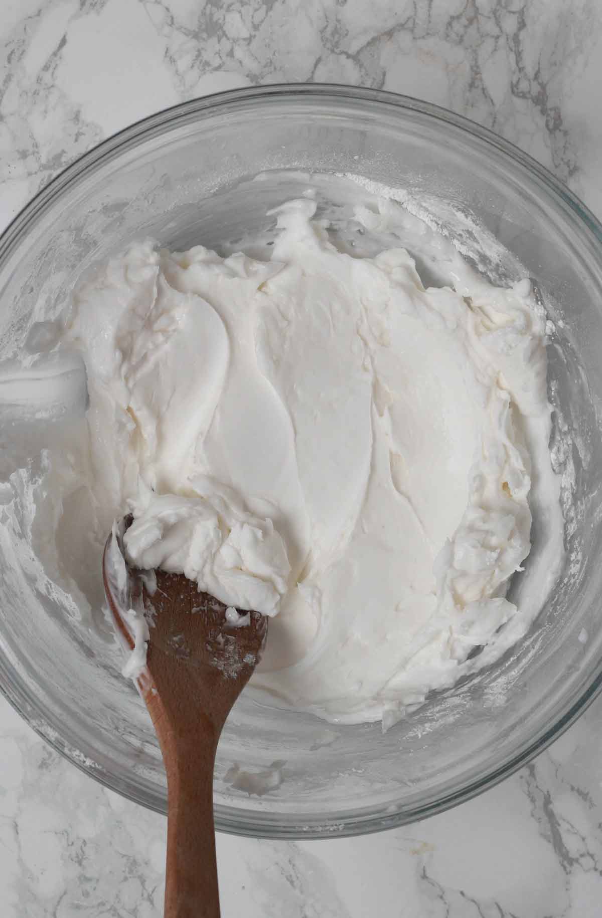 Cream Cheese And Icing Sugar Mixed Together In A Bowl