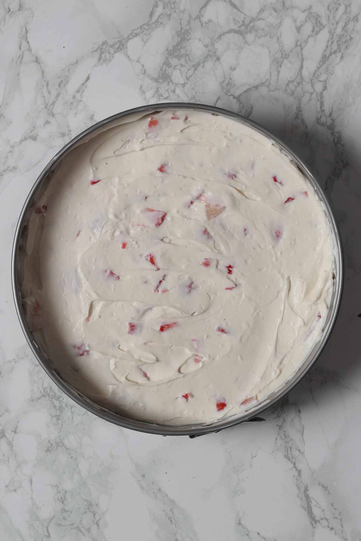 Cream Cheese Strawberry Filling On Top Of Biscuit Base In The Tin