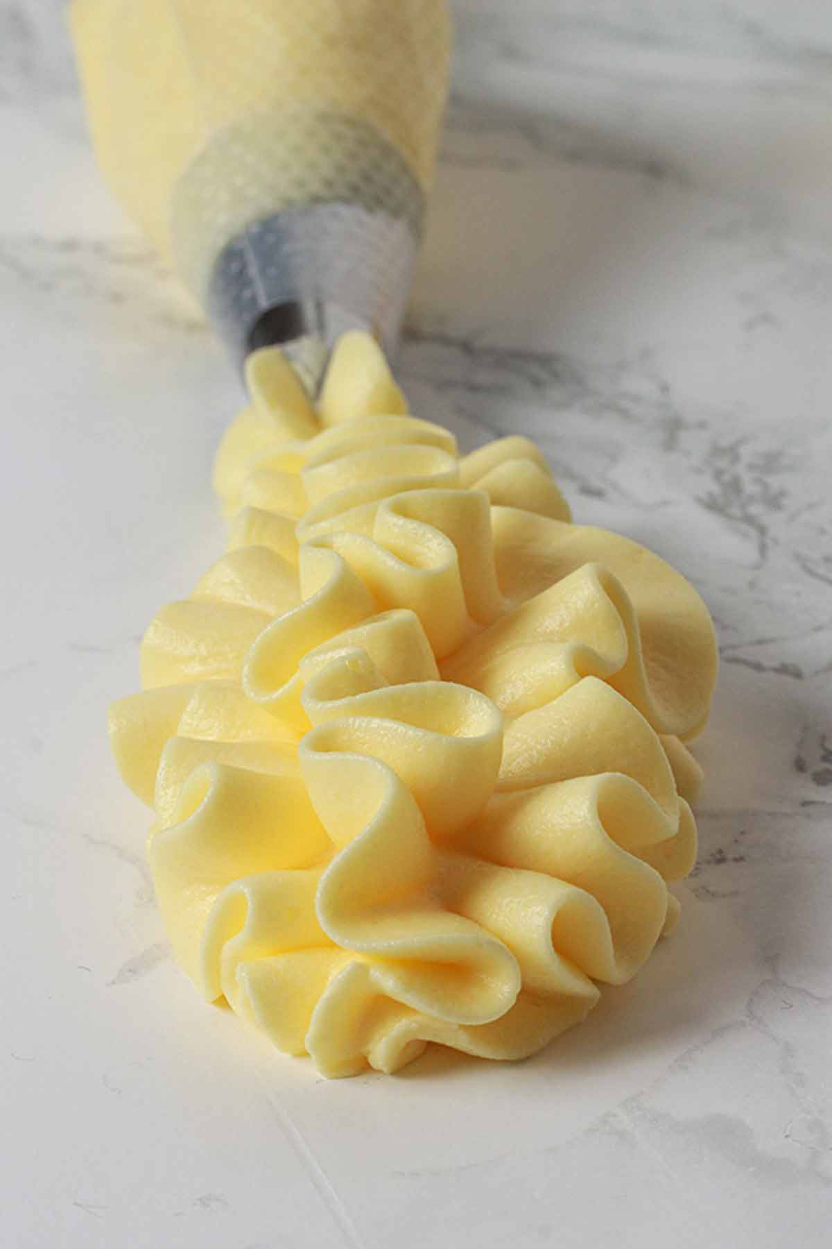Lemon Frosting Coming Out Of A Piping Bag
