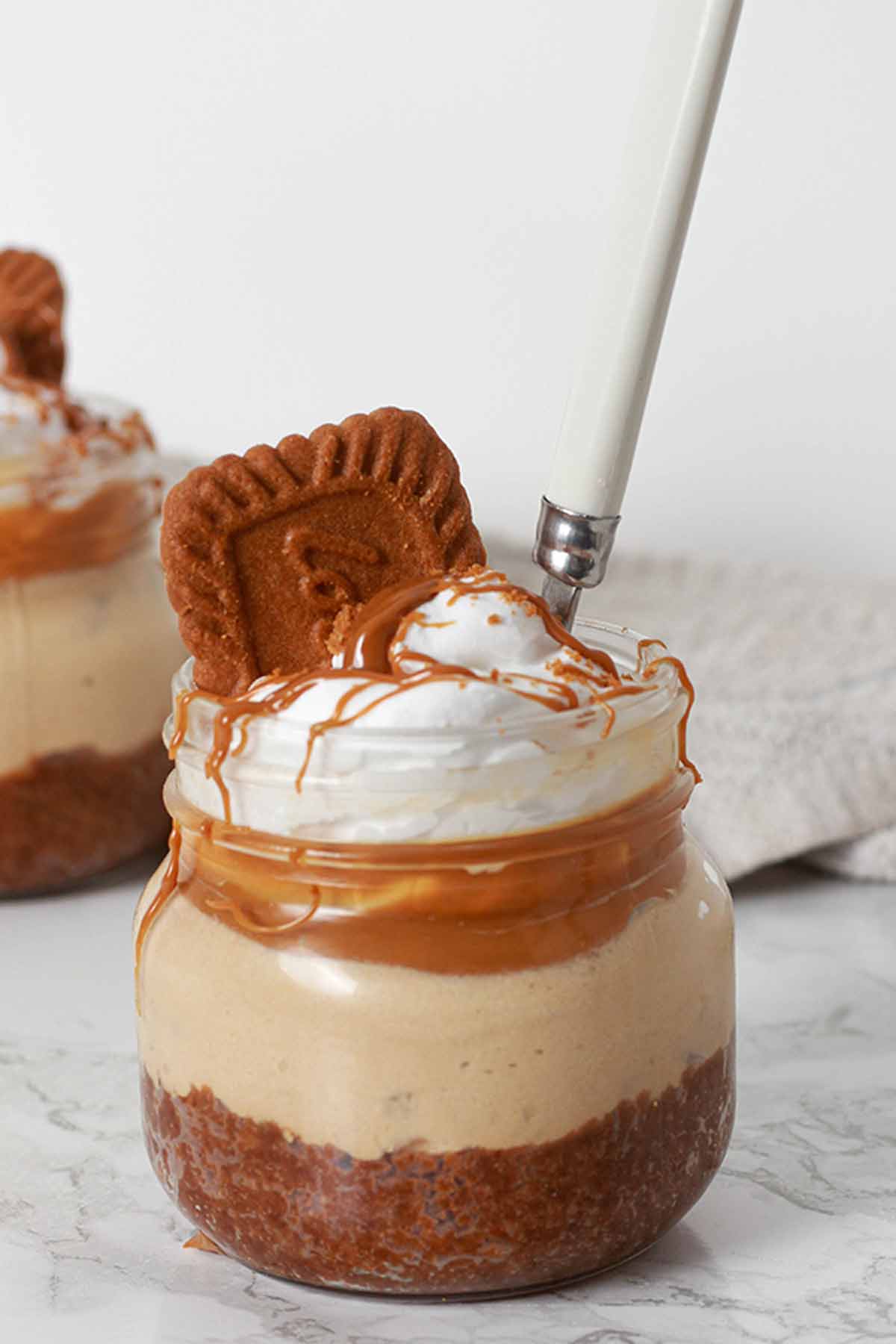 Vegan Biscoff Cheesecake Pot With A Small Spoon In It