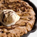 Thumbnail image- close up of cookie dough with ice cream and chocolate sauce on top