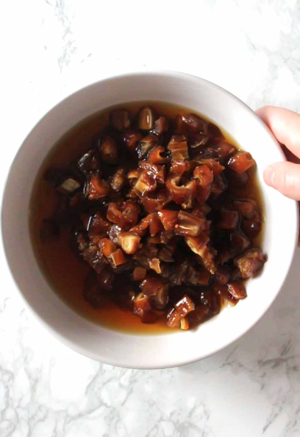 Dates In A Bowl With Hot Water