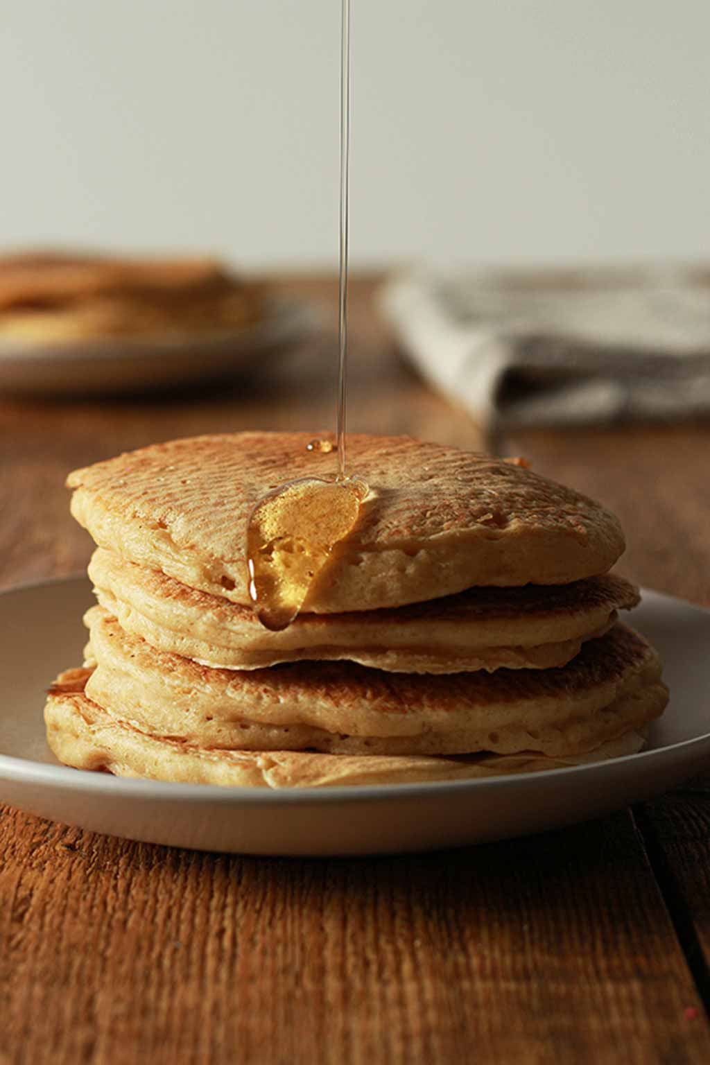 Pouring Syrup Onto A Stack Of Pancakes