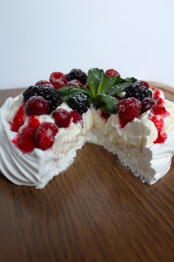 vegan pavlova with a slice taken out