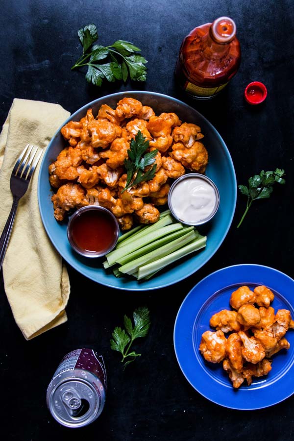 Buffalo cauliflower bites with celery and dipping sauces