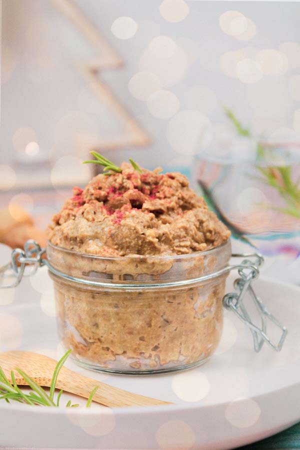 Lentil and walnut dip in an open jar with white background