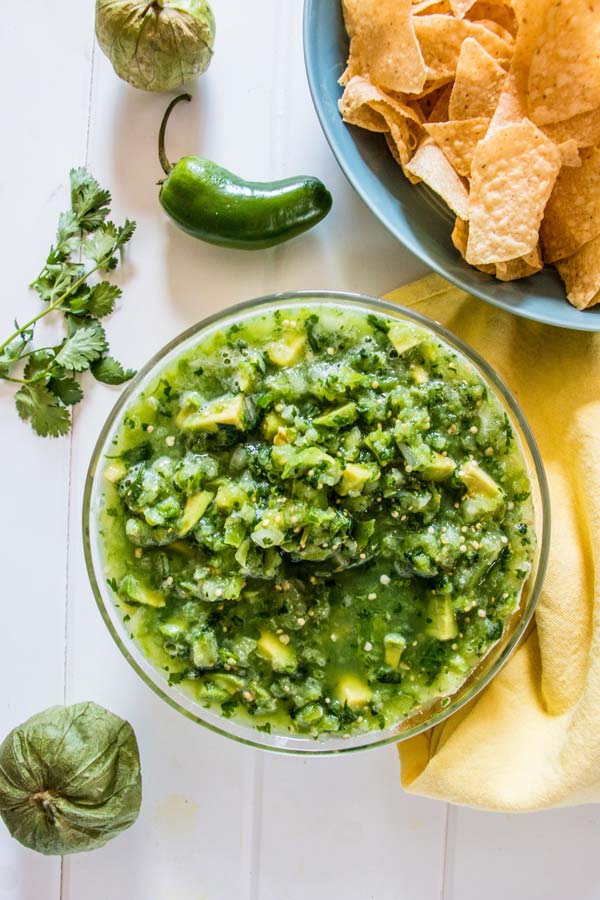 Overhead shot of salsa beside some garnishes