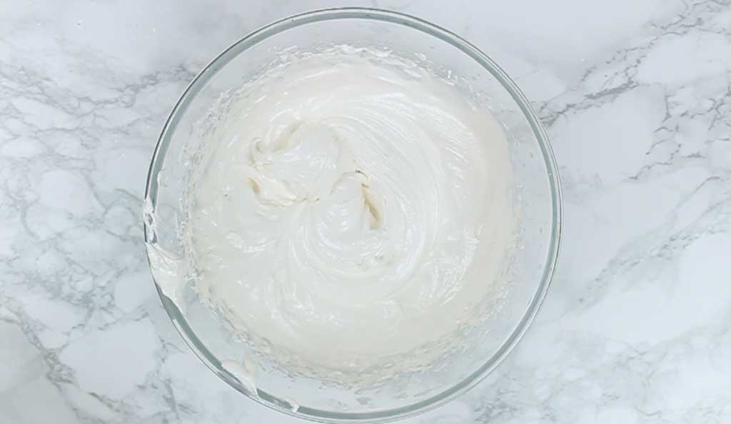 pavlova mixture in a bowl- it has now formed into stiff peaks