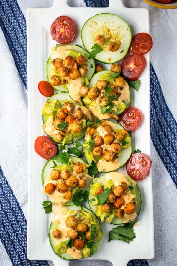 Overhead shot of cucumber bites beside sliced baby tomatoes