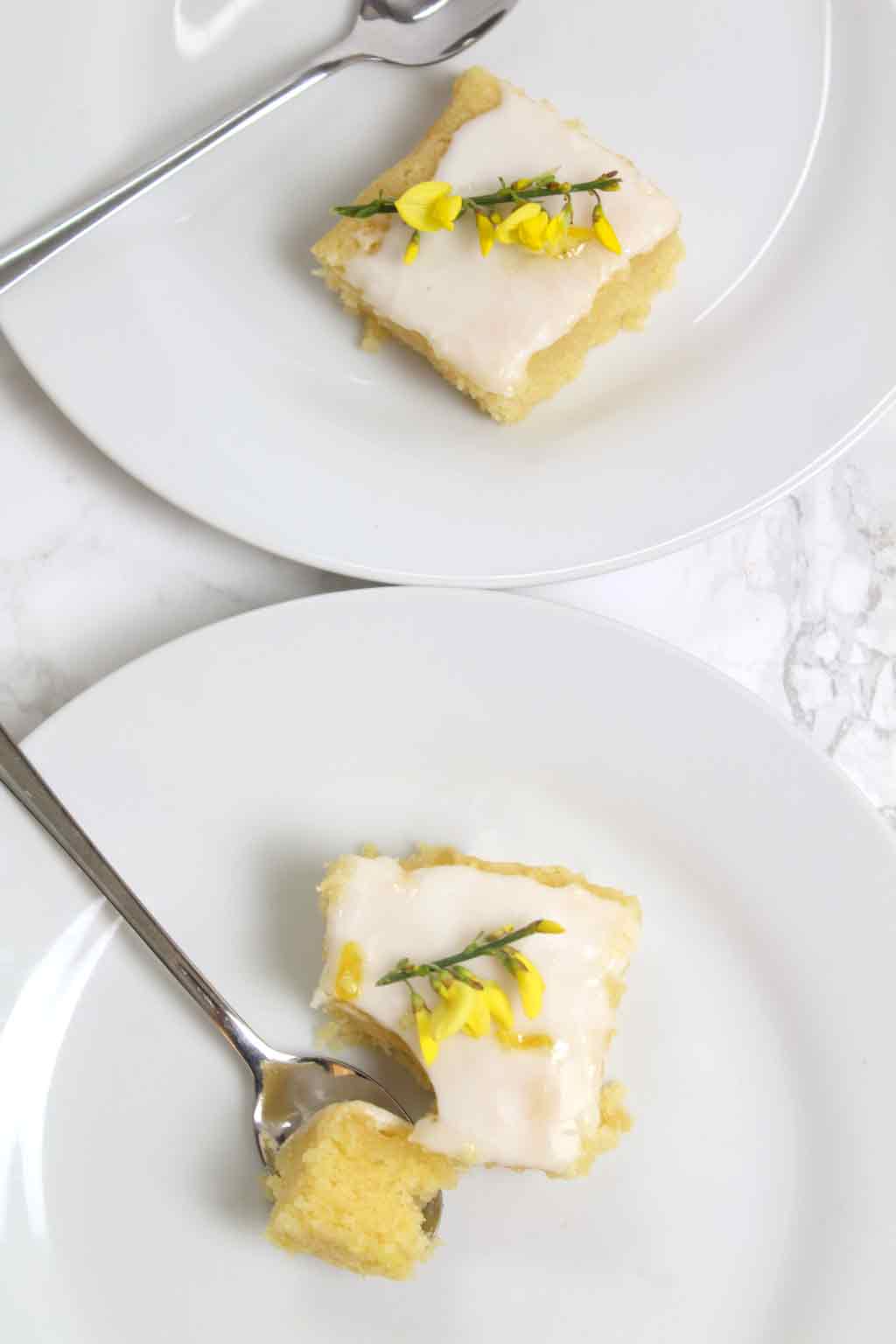 two slices of lemon cake on plates