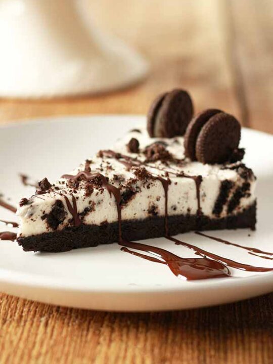 slice of Oreo Cheesecake on a white plate